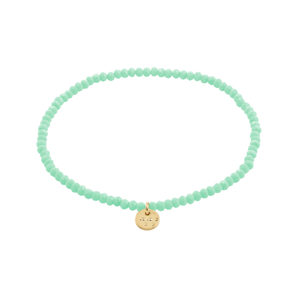 INDIE bracelet with mint-green faceted beads and a gold-tone disc charm, 17 cm stretch, from Pilgrim. Perfect for stacking and enhancing personal style.
