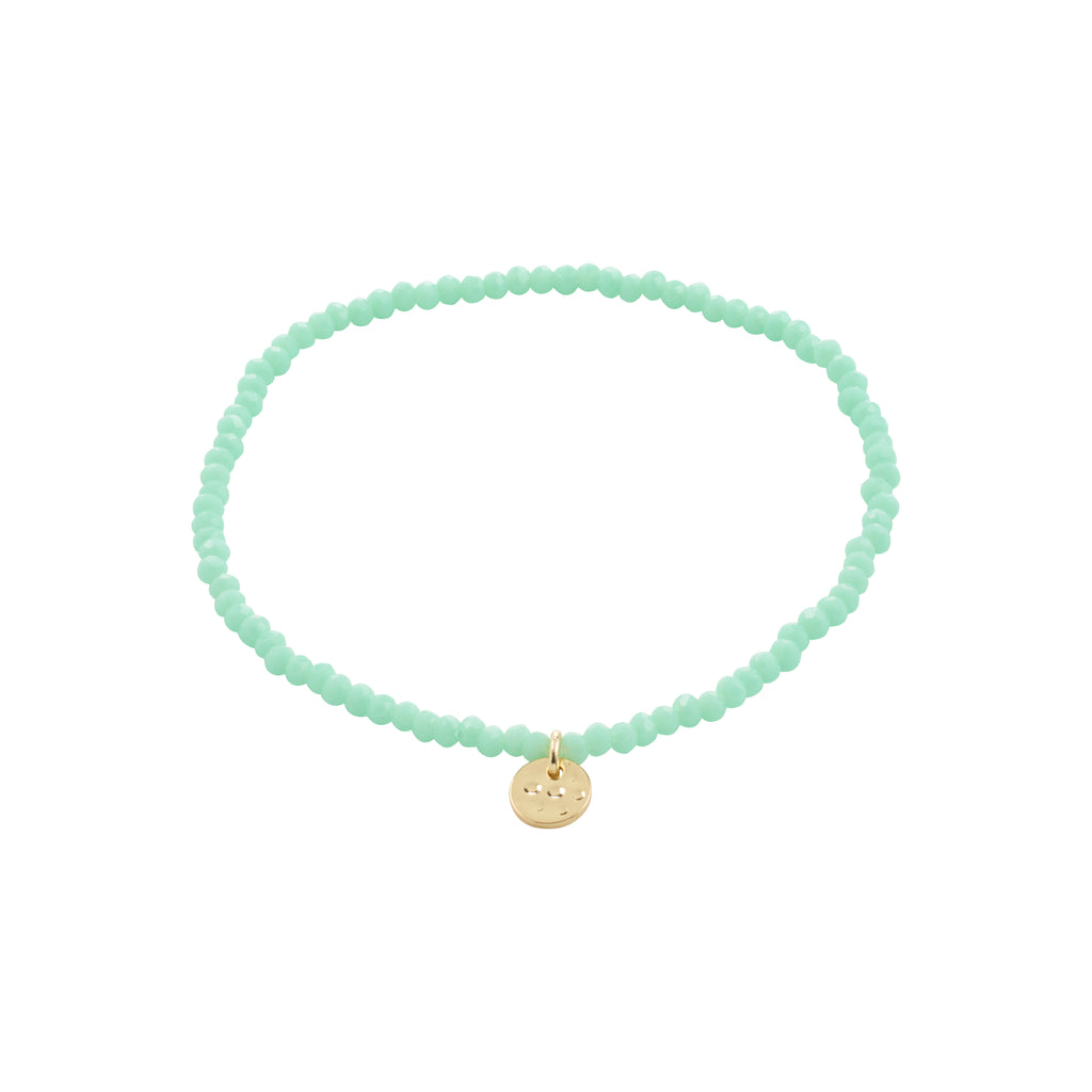 INDIE bracelet featuring mint green faceted glass beads and a gold-plated charm, highlighting Pilgrim's Scandinavian craftsmanship. Perfect for stacking, fits most wrists with elastic.