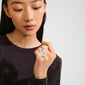 Woman wearing ADRIEL ring, a silver-plated, chunky, sculptural piece with an organic shape, showcasing edgy elegance and creative style.