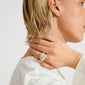 Close-up of a person wearing the silver-plated LAEL ring by Pilgrim, showcasing its wavy, pavé-style design with sparkling crystals on their hand.