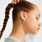 FENIX earrings silver-plated on a young woman; hoop features sparkling crystal embellishments for an elegant, dynamic look, embodying Pilgrim's blend of timeless and trendy style.