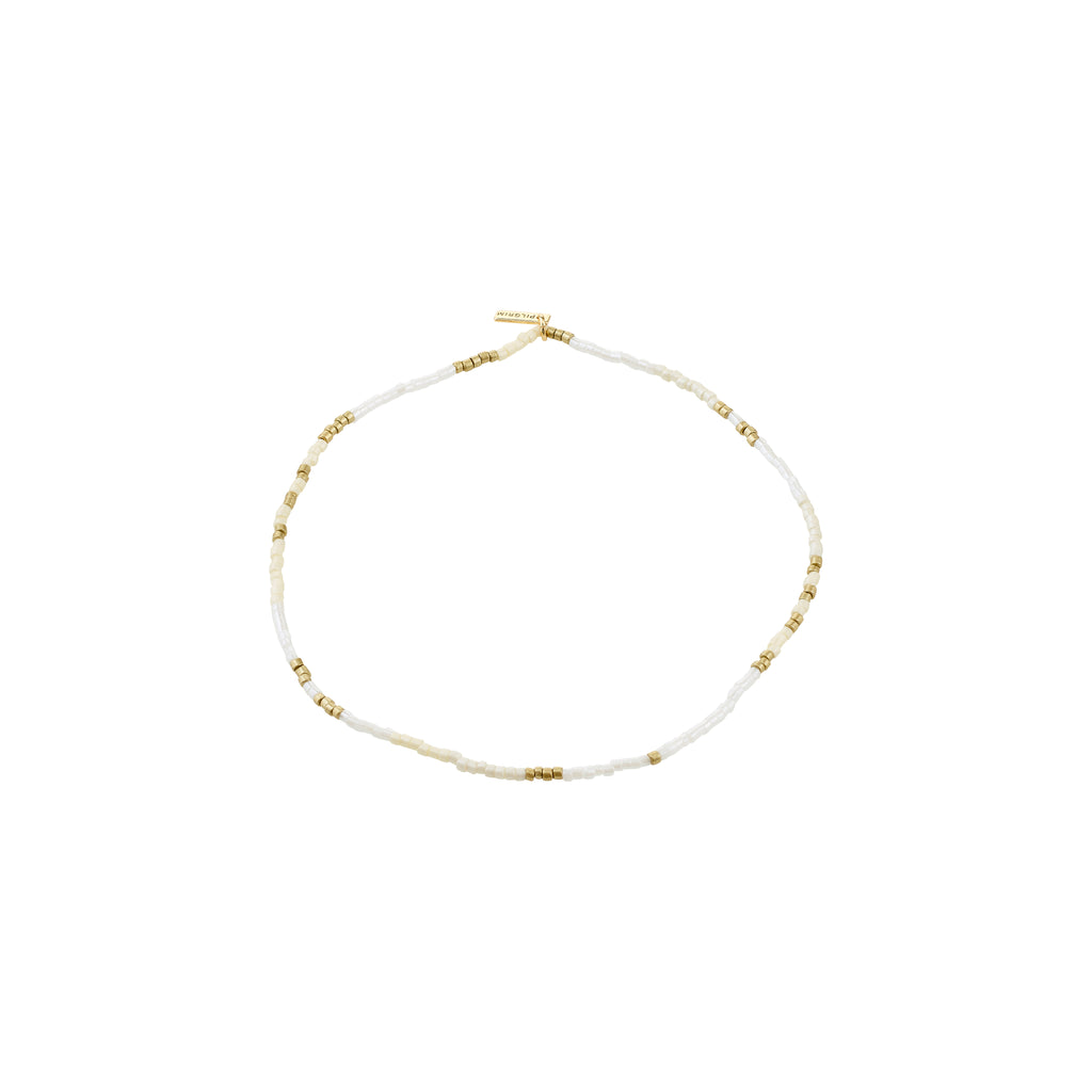 ALISON ankle chain in white and gold, featuring delicate seed beads and gold spacers, perfect for a boho summer look with comfortable lycra elastic.