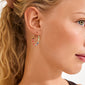 Close-up of a woman's ear wearing ALISON earrings by Pilgrim, featuring multicolored beaded hoops for a vibrant, boho-chic look.