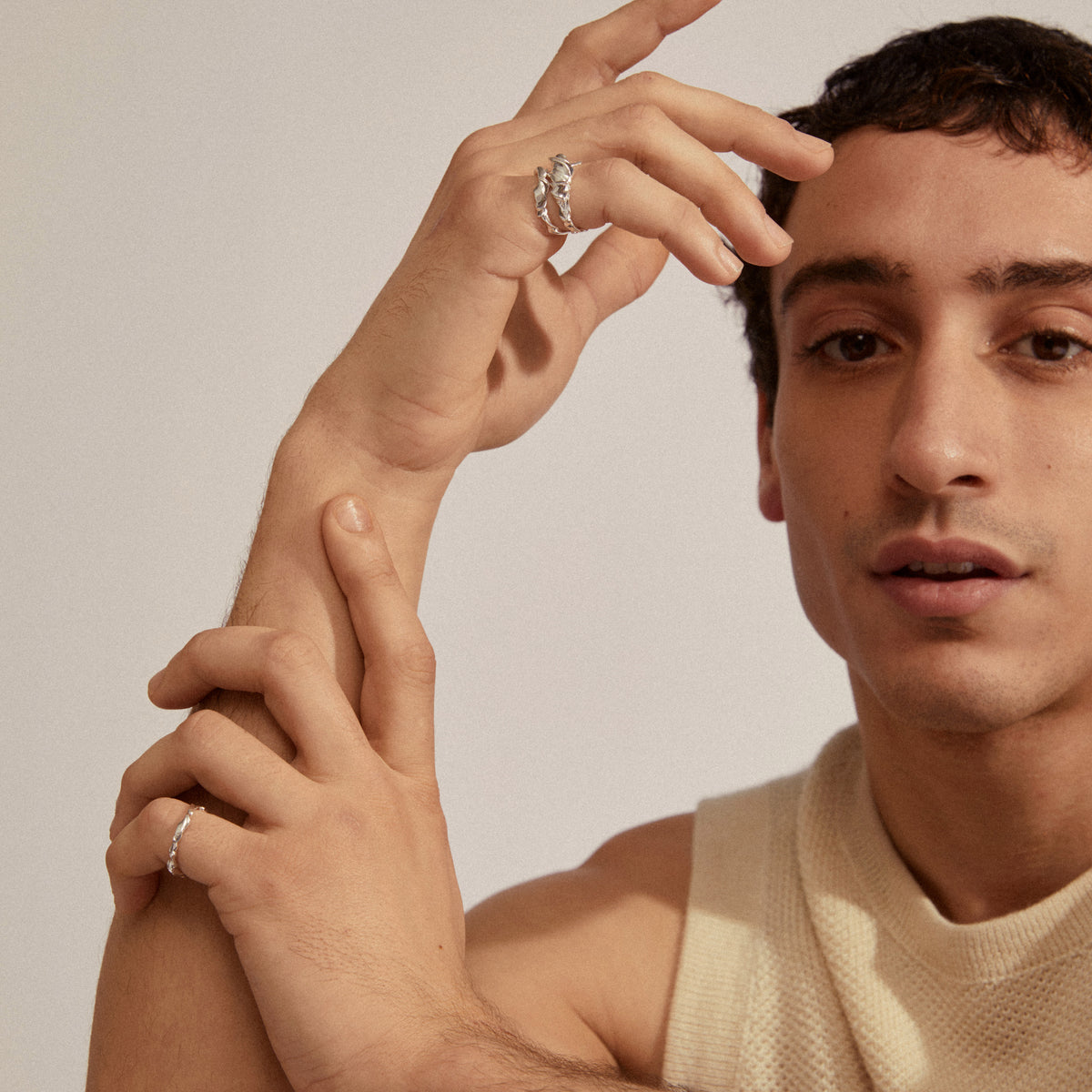 Young man wearing STORM rings 3-in-1 set silver-plated, showcasing chunky, sculptural design for a modern, adventurous look. Rings are adjustable and crafted from 99% recycled material.