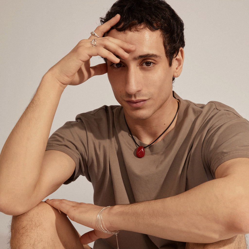 Young man wearing STORM rings 3-in-1 set silver-plated, showcasing two silver rings with unique contours on his right hand, embodying an adventurous, handcrafted style.