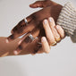 Close-up of ASHER rings 4-in-one silver-plated set on hands, showcasing wavy design and stacked look, highlighting Pilgrim's handcrafted Scandinavian style.