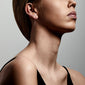 PEONY earrings, rose gold-plated, showcased on a woman with a short haircut, highlighting the timeless elegance and simplicity of these pull-through earrings.