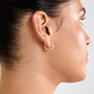 Side profile of an ear wearing Pilgrim's TAFFY medium gold-plated swirl hoop earring, showcasing its twisted-rope design and vintage-inspired, nature-inspired curves.