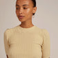 Woman wearing APRIL medium-size gold-plated hoop earrings, showcasing their versatility and timeless style. Perfect for trendy ear curation, aligning with Pilgrim's inclusive and fashionable ethos.