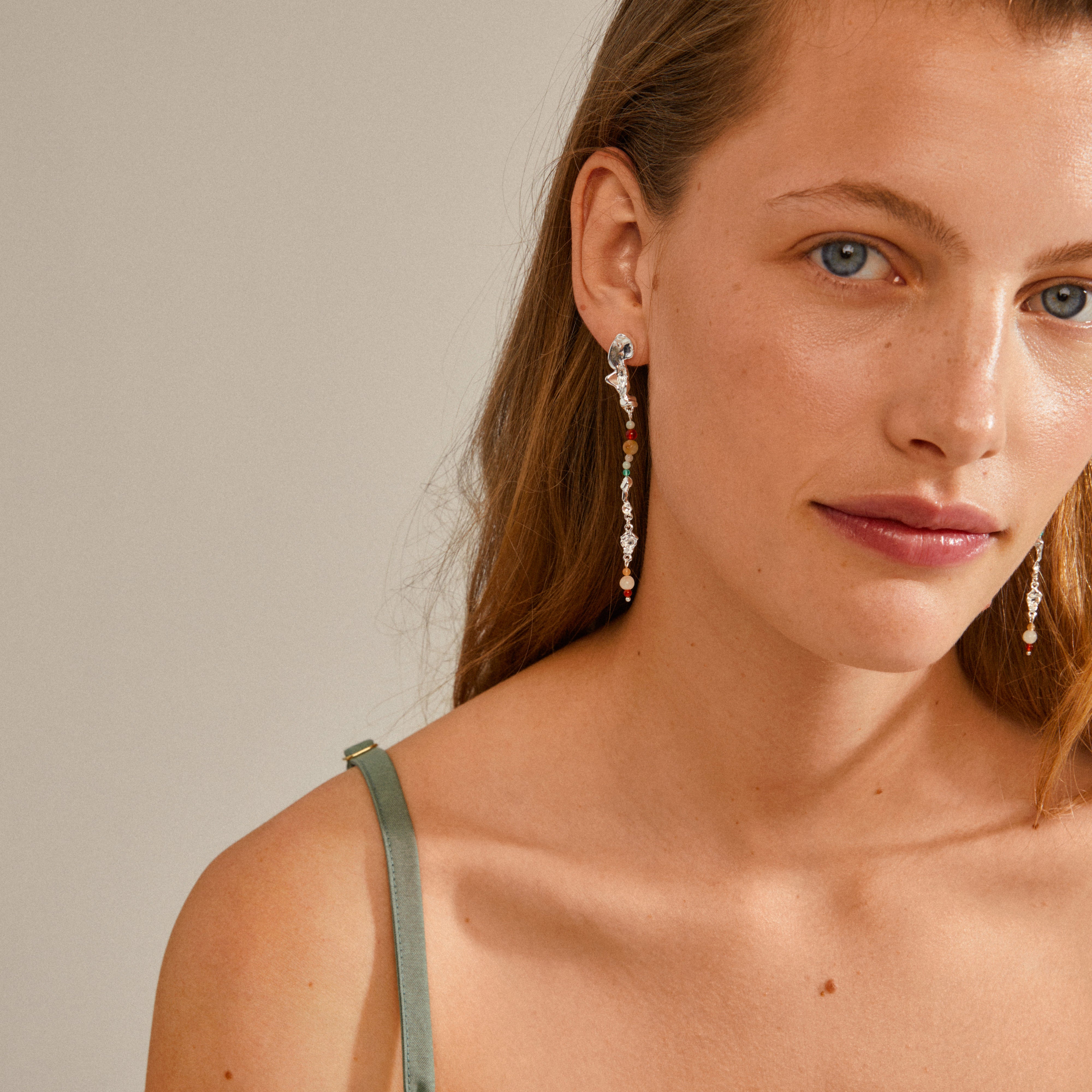 NIYA earrings multi-coloured/silver-plated, featuring long, colourful beads on a woman with long hair, embodying summer vibes and Scandinavian elegance.