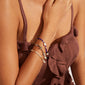 INDIANA bracelet white featuring freshwater pearls, grey agate, and faceted glass beads on a woman's arm, showcasing its trendy, stacked look and organic style.