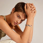 Woman wearing the INDIANA bracelet, featuring genuine freshwater pearls and amethyst stones, styled in a trendy, stacked look.