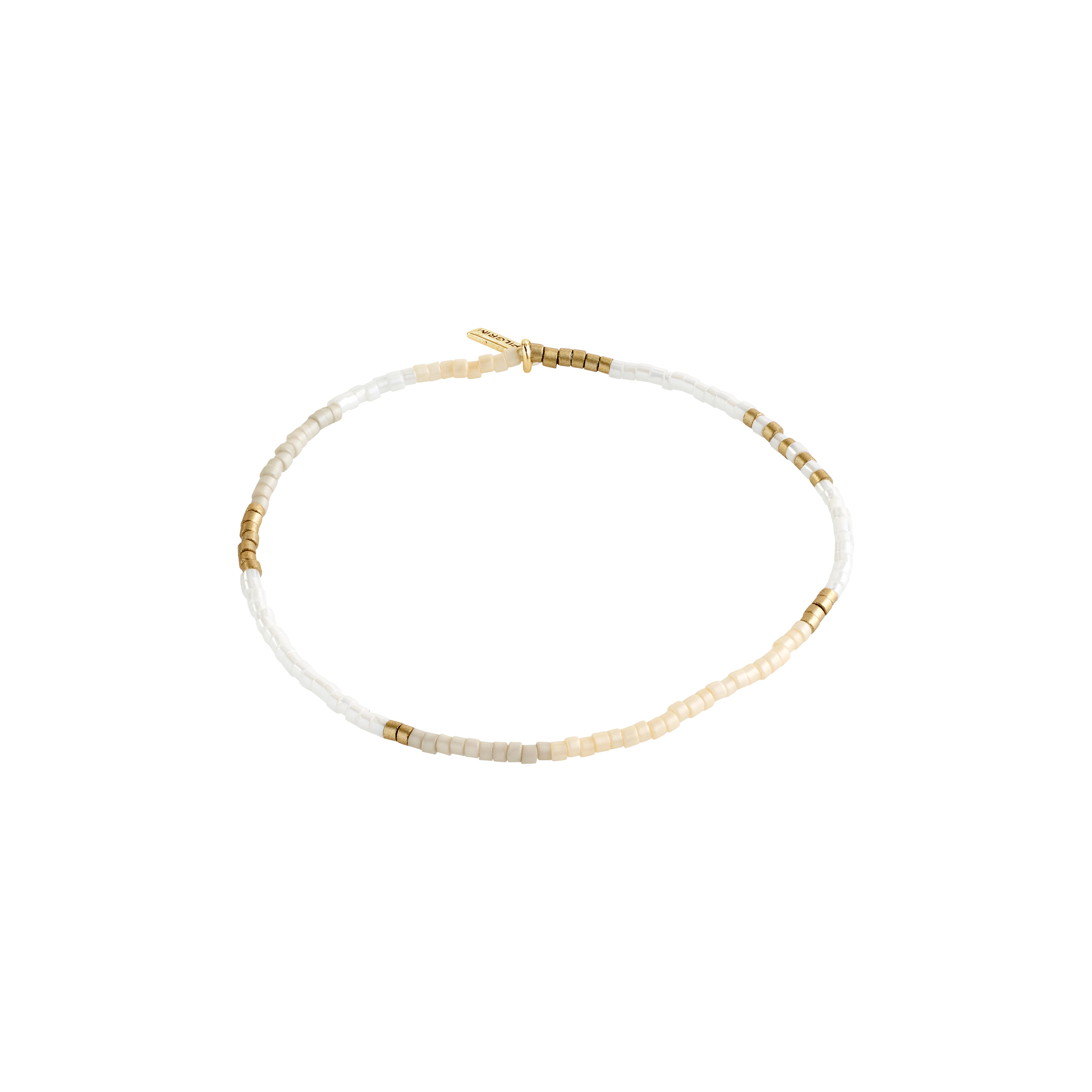 ALISON bracelet featuring white and gold beaded design, perfect for stacking. Made with durable elastic for a comfortable fit. Ideal for a boho-inspired, laid-back style.