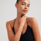 Woman wearing the Pilgrim ALISON bracelet, featuring white and grey glass beads on a lycra elastic band, perfect for stacking with other bracelets.