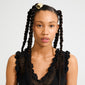 Young woman wearing the AMARIS hair accessory, a sleek gold-plated clip, adds elegance to her two-strand twist pigtails. Perfect for elevating everyday hairstyles.