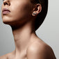 Close-up of a woman's ear adorned with the MILLIE 3-in-1 set of silver-plated crystal studs, showcasing versatile, elegant earring options.