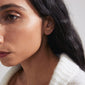 PRISKILLA single earring gold-plated, featuring an elegantly twisted snake design, symbolizing renewal, crafted with 98% recycled material for a unique, stylish look.