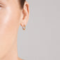 KYRA single earring gold-plated, featuring a small, textured hoop with a shiny finish and click clasp, elegantly showcased on a person's ear.