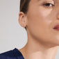 KRISTINE single earring gold-plated, featuring three sparkling Preciosa crystals, shown worn by a woman, highlighting its elegant design and craftsmanship.