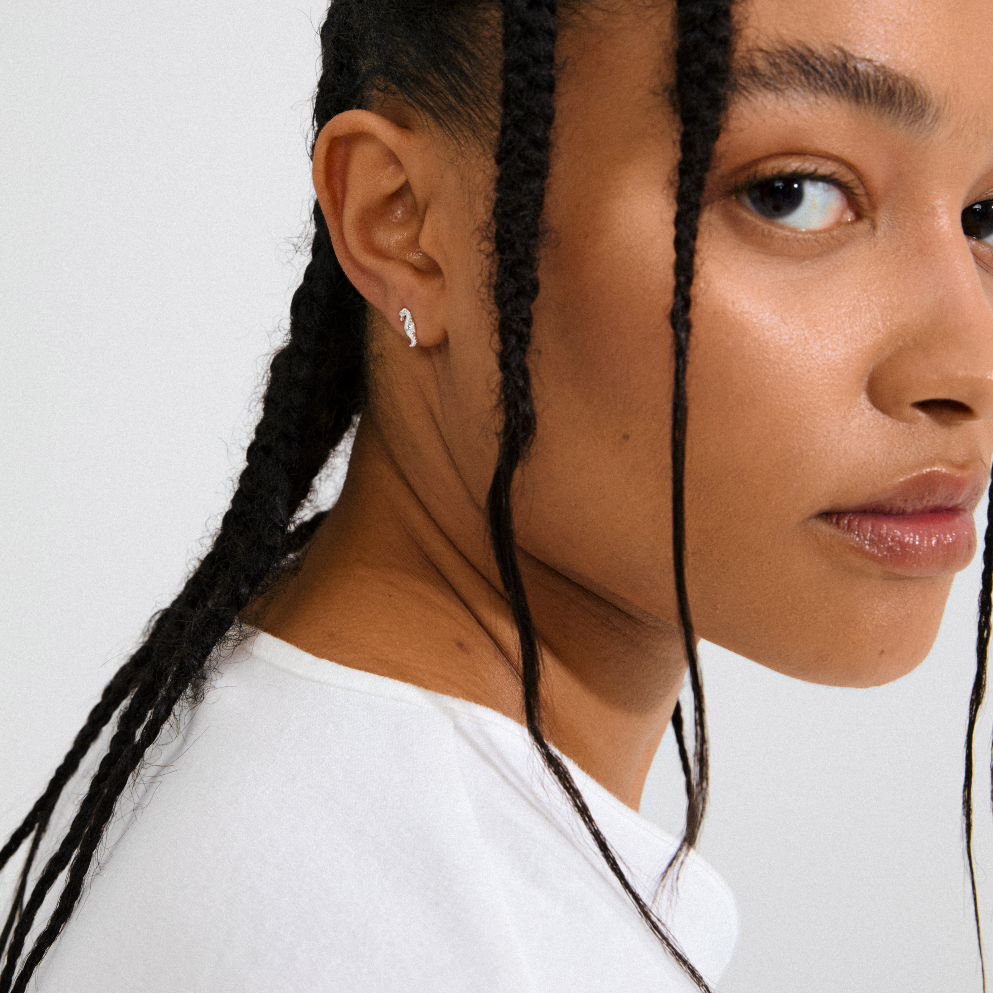 Silver-plated LYRIC single earring, featuring a tiny seahorse design, offering an oceanic vibe; crafted from 99% recycled materials by Pilgrim.