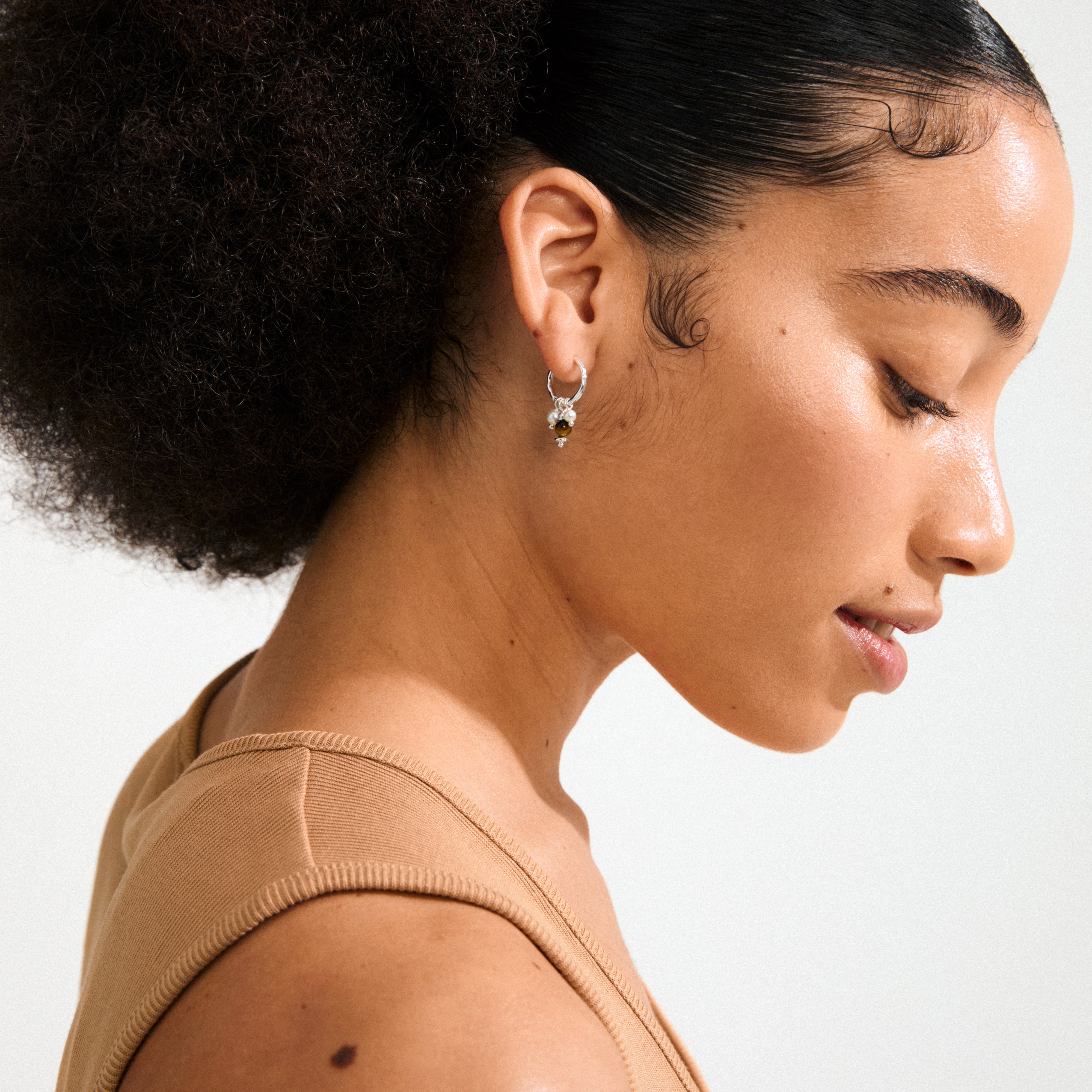 Silver-plated ROYAL single earring featuring a Tiger Eye pendant and mother-of-pearl beads, designed with a click clasp for versatile styling.