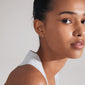 ZOE single earring in silver-plated design, featuring colorful Preciosa crystals, showcased on a woman's ear with a ponytail, highlighting its classic, versatile style.