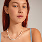 Woman with red hair wearing the RAMONA freshwater pearl necklace, silver-plated, featuring irregular pearls and amazonite stones for a playful, contrast-filled look.