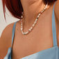 Close-up of neck wearing the RAMONA freshwater pearl necklace, silver-plated, featuring irregular pearls and colored beads. A playful, classic piece from Pilgrim's Energetic collection.