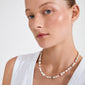 Young woman wearing Pilgrim's RAMONA freshwater pearl necklace, featuring irregular pearls and colorful beads, showcasing natural beauty and unique design with a silver-plated chain.