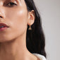 SIBYLLA single earring gold-plated, featuring a decorative triangle with Preciosa crystals, worn by a woman, showcasing Pilgrim's edgy, recycled, and personalized design.
