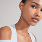TITANIA single earring gold-plated, featuring a sun pendant with Preciosa crystal, worn by a woman. Perfect for a lux boho vibe.