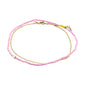 PALOMA ankle chains 2-in-1 set featuring purple pearls and a gold-plated chain, offering a playful and elegant summer accessory from Pilgrim.