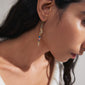 SELENE single earring gold-plated featuring a handcrafted design with colorful beads, worn by a woman, showcasing a playful, boho-chic style.