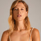 LEAF twirl hoops gold-plated, chunky twisted design, worn by a woman, showcasing Pilgrim's recycled beauty and eco-friendly craftsmanship.