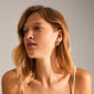 LEAF twirl hoops gold-plated, featuring a chunky twisted design, worn by a woman looking sideways, part of Pilgrim's recycled collection, showcasing sustainable elegance.