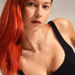 Woman with red hair wearing LEAF 2-in-1 set necklaces, featuring a twisted rope and flat snake chain, showcasing Pilgrim's recycled silver-plated jewelry.