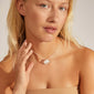 Woman wearing CHARM love pendant necklace, featuring silver-plated heart charms, ideal for gifting or personal style, reflecting Scandinavian quality and trendy design.