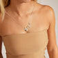 Woman models the CHARM love pendant silver-plated necklace, featuring two heart-shaped charms, ideal for gifting or personalizing with meaningful pendants.
