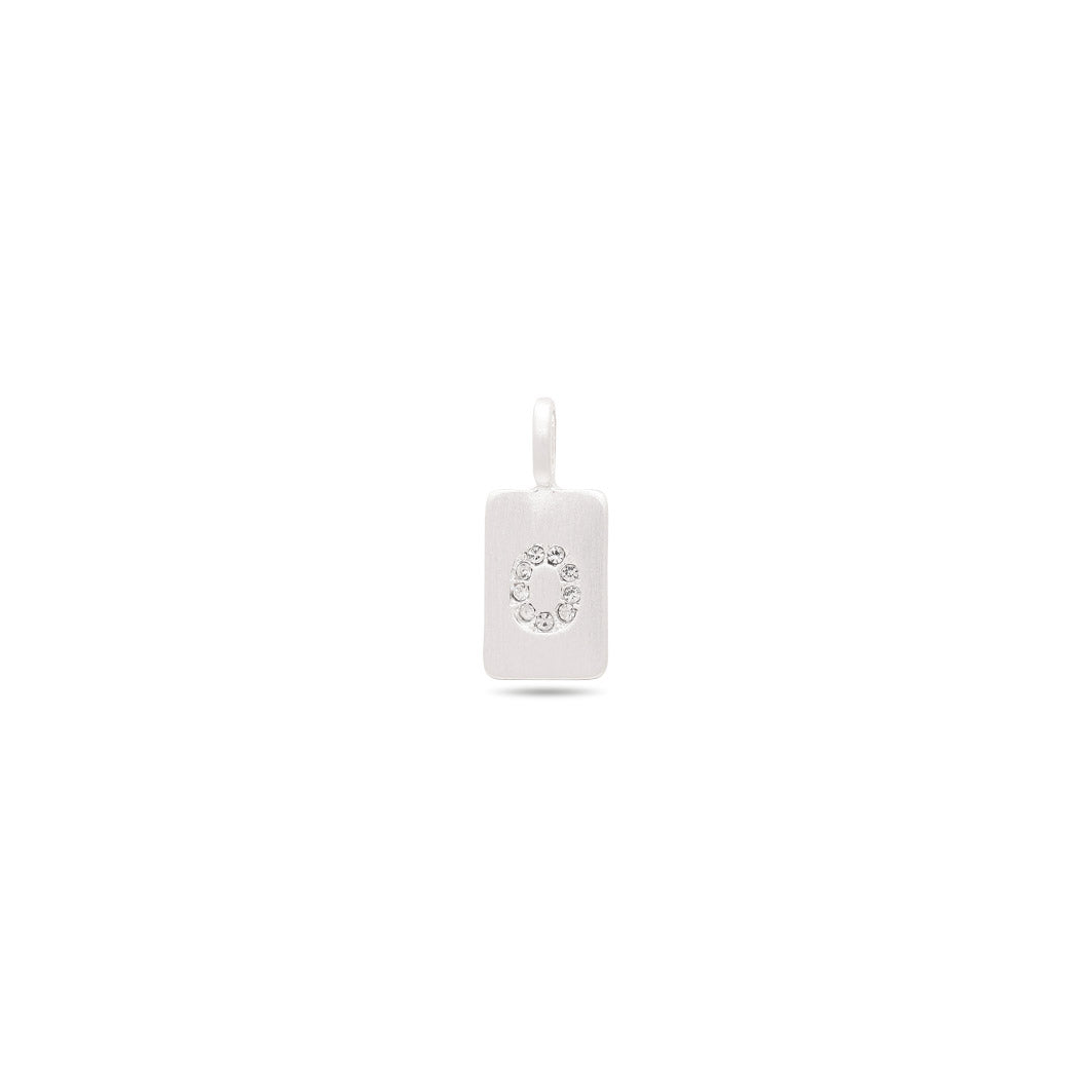 Close-up of the CHARM crystal O pendant, silver-plated, showcasing its minimalist design with sparkling crystals on a satin matt surface.