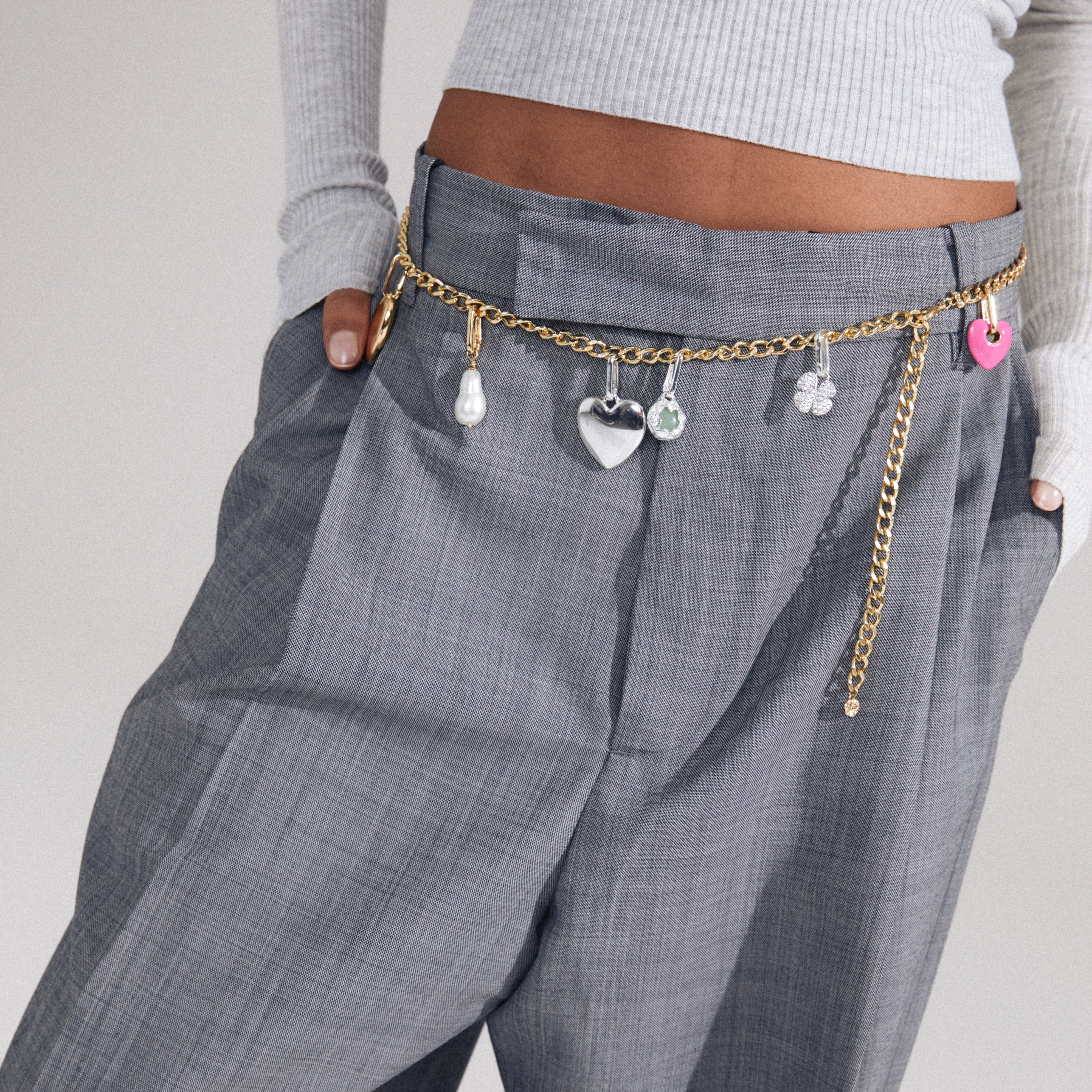 Close-up of the CHARM curb necklace gold-plated, featuring a heart pendant and chain detail, highlighting its adjustable, edgy design for personal styling.