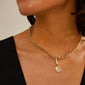 Woman wearing the CHARM moon pendant, gold-plated, on a chain, showcasing Pilgrim's blend of timeless and trendy Scandinavian jewellery design.