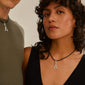 Woman wearing Pilgrim's CHARM pendant A, silver-plated necklace, showcasing a rustic letter design for a unique, personalized style.