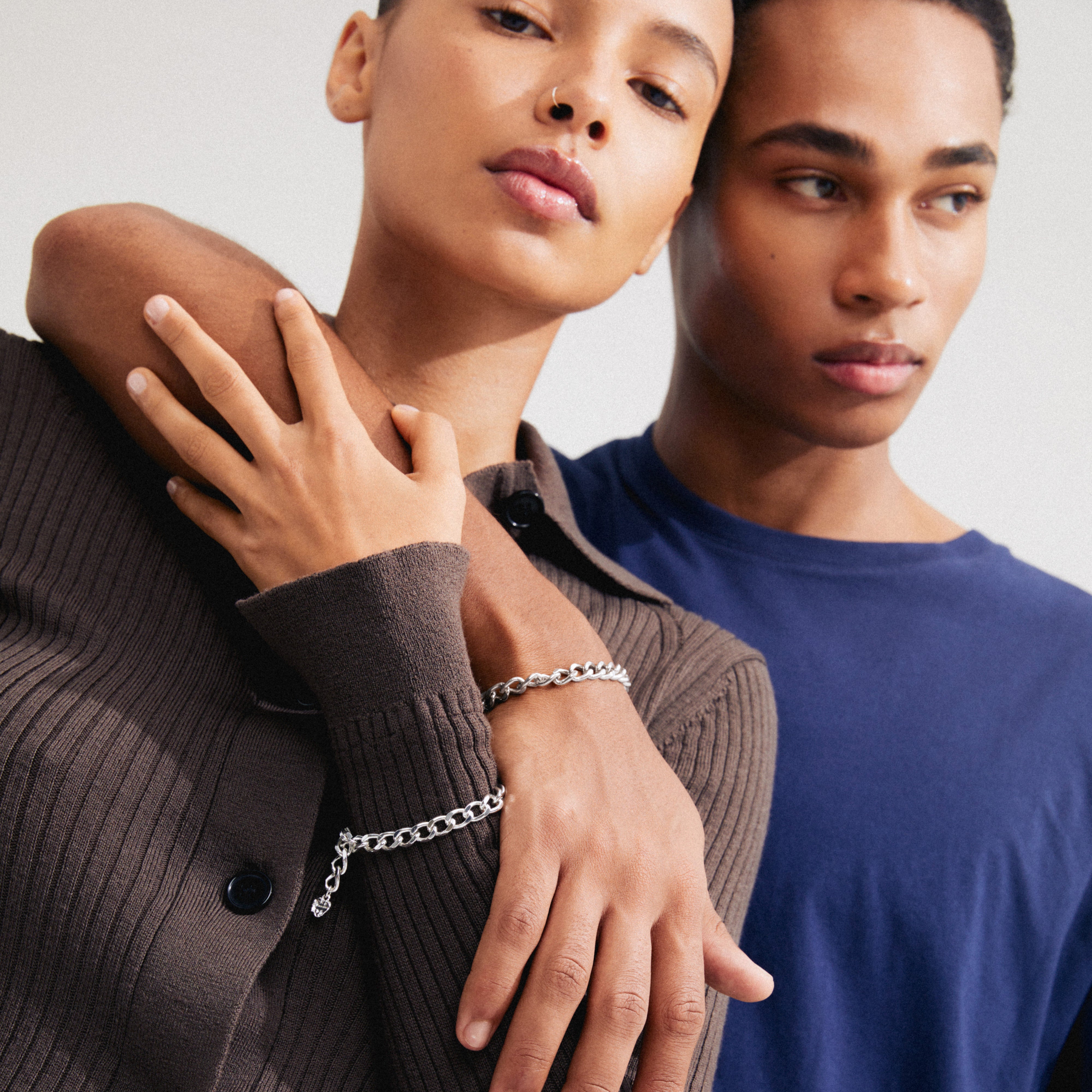 CHARM curb chain bracelet silver-plated, showcased on a woman's wrist, features a bold, adjustable design ideal for stacking and personalization with charms.