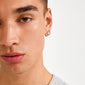 Close-up of a young person wearing CHARM small gold-plated hoop earrings, designed for personalized charm additions, ideal for creating a signature look.