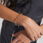Person wearing the CHARM bracelet gold-plated, featuring a delicate, adjustable cable chain design, perfect for adding charms and achieving a stacked bracelet look.