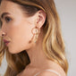 CHARM large hoop earrings gold-plated, worn by a woman with long blonde hair, showcasing their elegant design perfect for adding personalized charms.