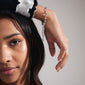 Silver-plated CHARM bracelet on a woman's wrist, showcasing its delicate cable chain design, ideal for adding charms and creating a trendy stacked look.