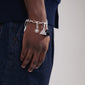Silver-plated CHARM bracelet featuring a triangle and sun pendant on a cable chain, worn by a person, showcasing its adjustable, trendy design.