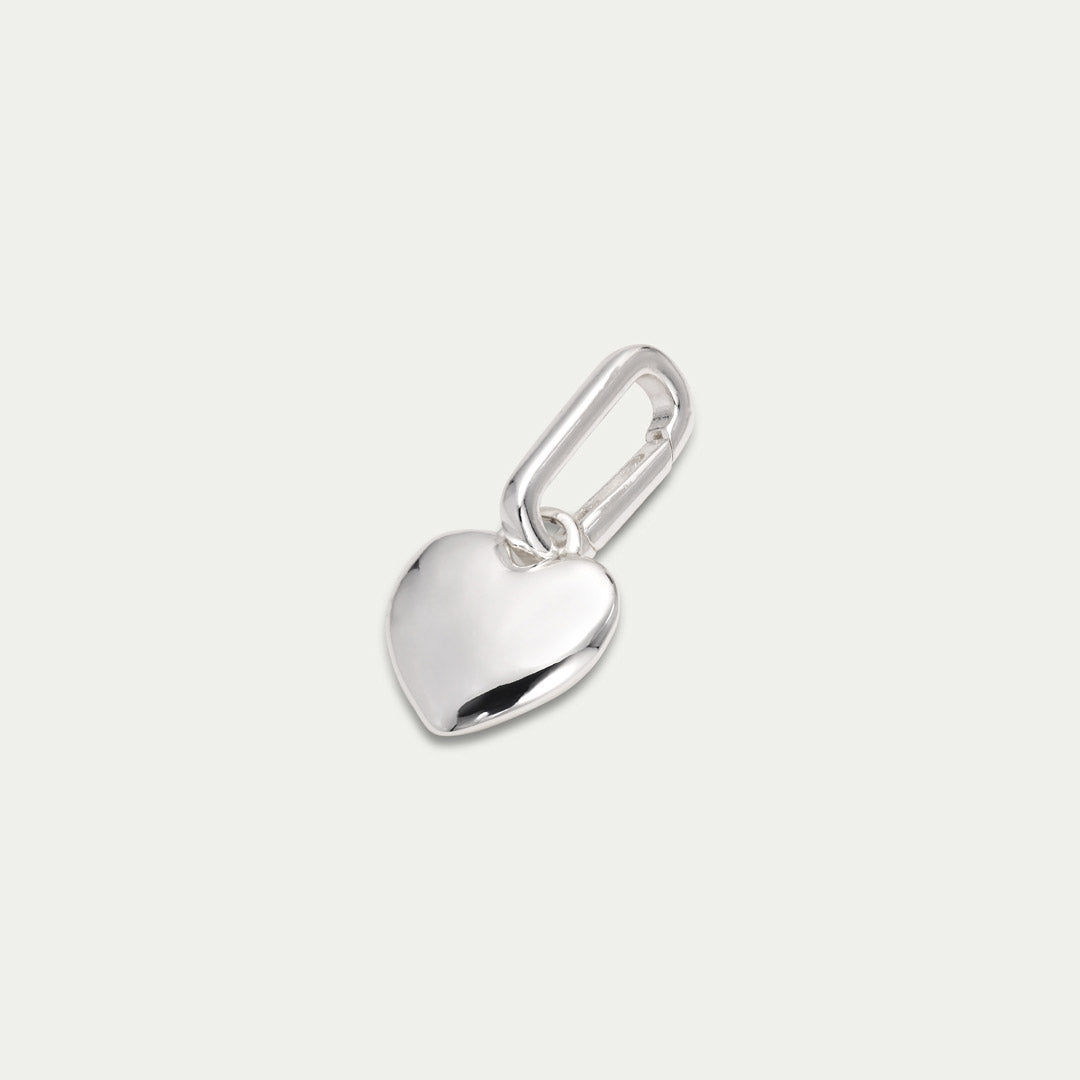 Silver-plated heart pendant charm by Pilgrim, perfect for personalizing your style with recycled materials, ideal for attaching to chains or hoops.