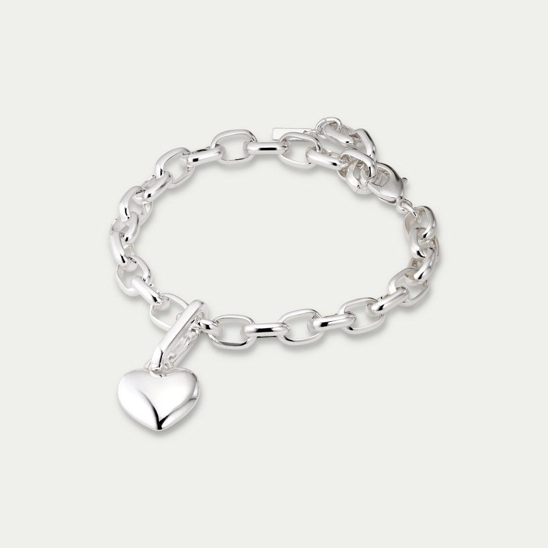 Silver-plated CHARM heart pendant on bracelet, showcasing Pilgrim's unique, trendy design, made from 99% recycled materials for a personalized, sustainable style statement.